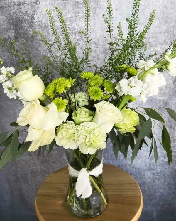 floral arrangement for sympathy with white and green tones