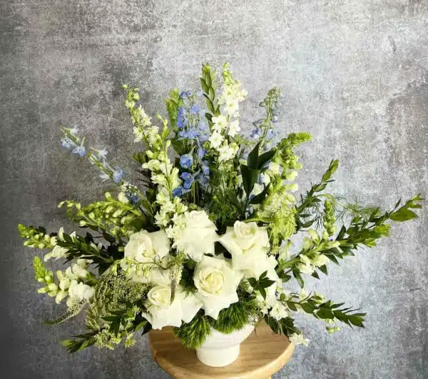 Our Green Meadow arrangement is a natural and fresh bouquet with green, white, and blue flowers, including Gladiolus and Delphinium, for sale at our Washington, NC, florist.