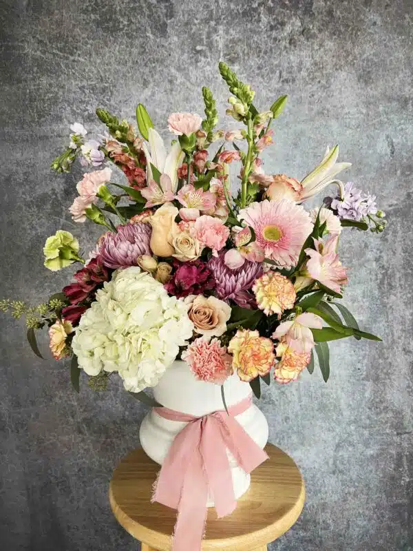 A romantic and abundant bouquet of flowers, including Peonies and Roses, for sale at our Washington, NC, florist.